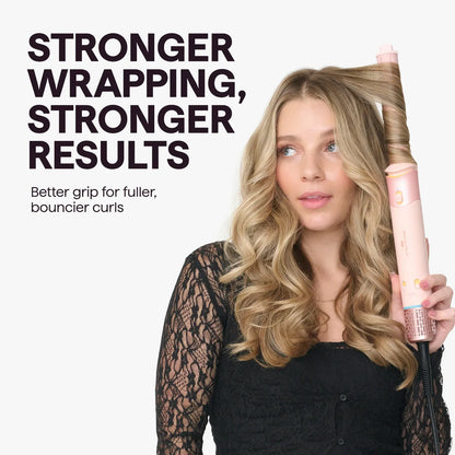 A woman with long blonde wavy hair holds a pink curling iron against her hair, with bold text on the left reading 'STRONGER WRAPPING, STRONGER RESULTS' and smaller text below.